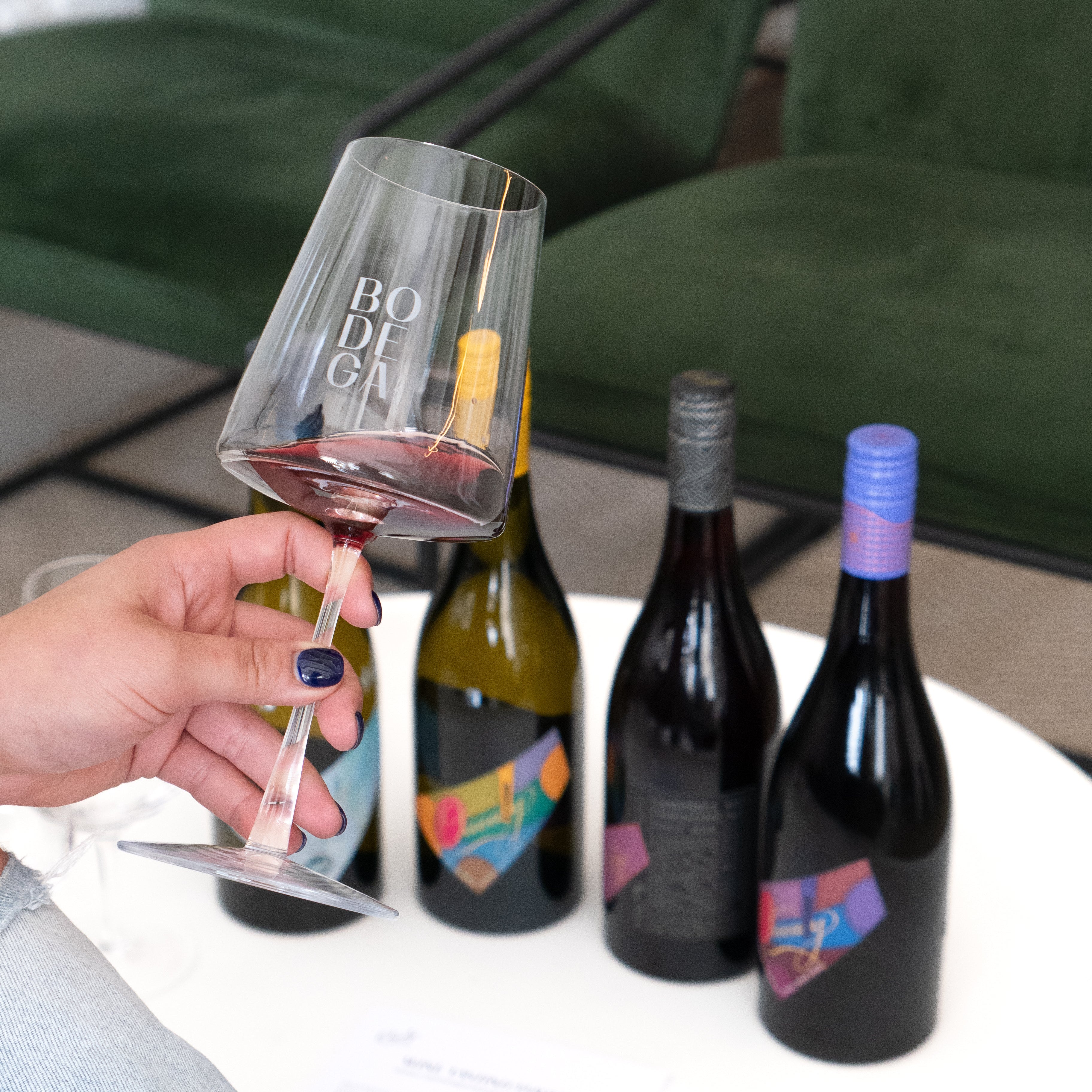 Bodega glass with four bottle of quealy wine: pinot gris, Pinot noir, Chardonnay